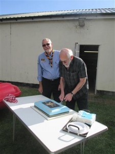 3rd Osterley Sea Scouts Anniversary 27Sep15. Alan Perry cutting the cake, a Troop Scout Leader in the 1960’s and a member of the Group Trustee’s, with Brian Mitten, Group Scout Leader